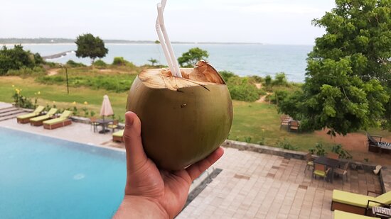Close-up of fresh coconut water being poured into a glass